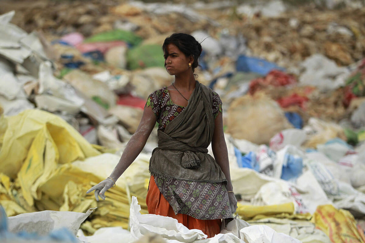 Seorang pemulung India mengumpulkan kantong plastik di kawasan industri di pinggiran Jammu, India, 5 Juni 2018